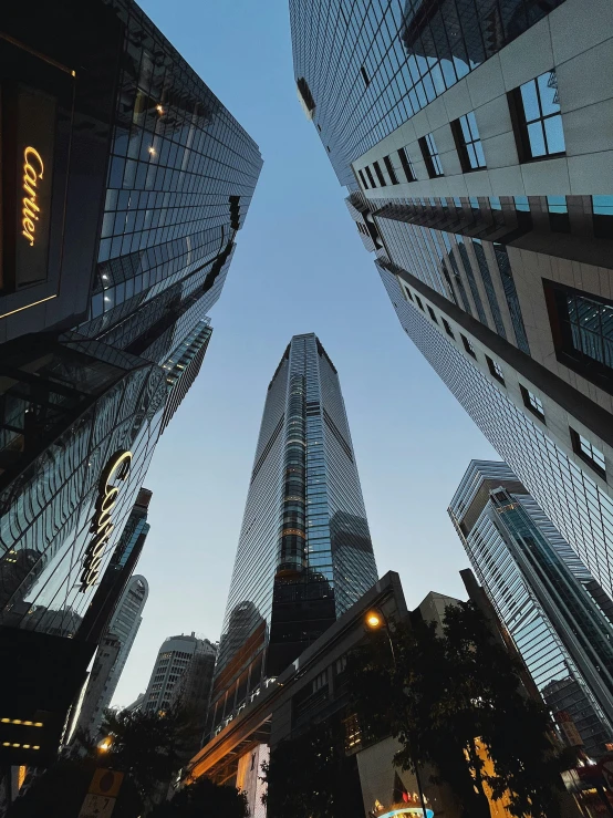 three glass buildings with reflections in them