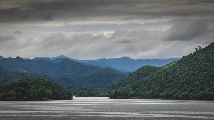 a beautiful view of trees on mountains from the water