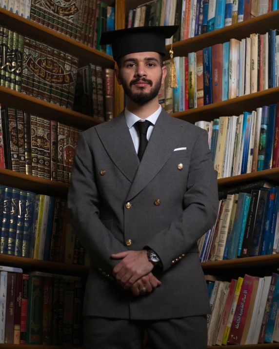 a man in a suit and tie in front of bookshelves