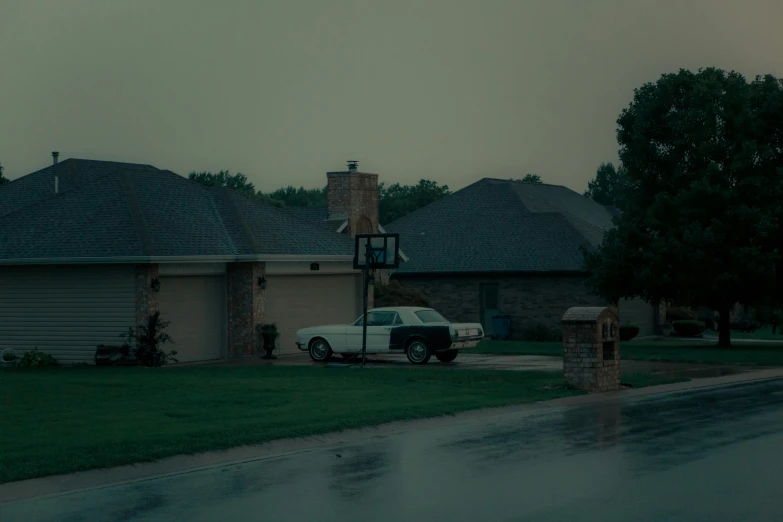 a white car parked in front of a house