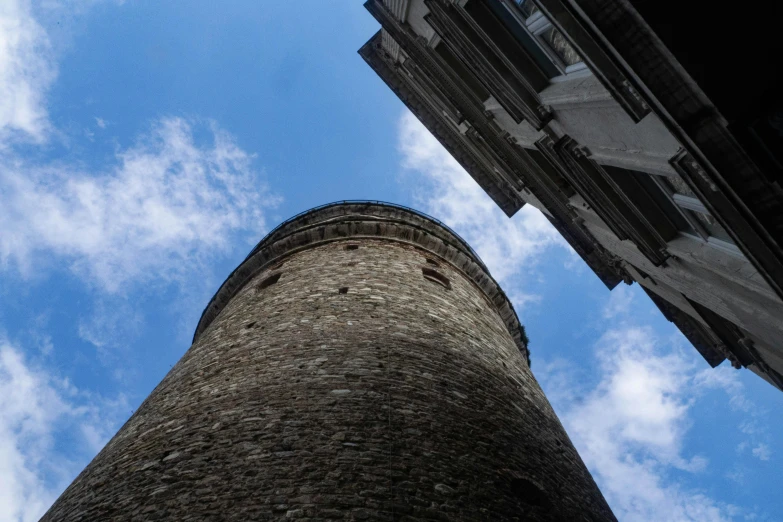 the top of an old stone tower against a blue sky