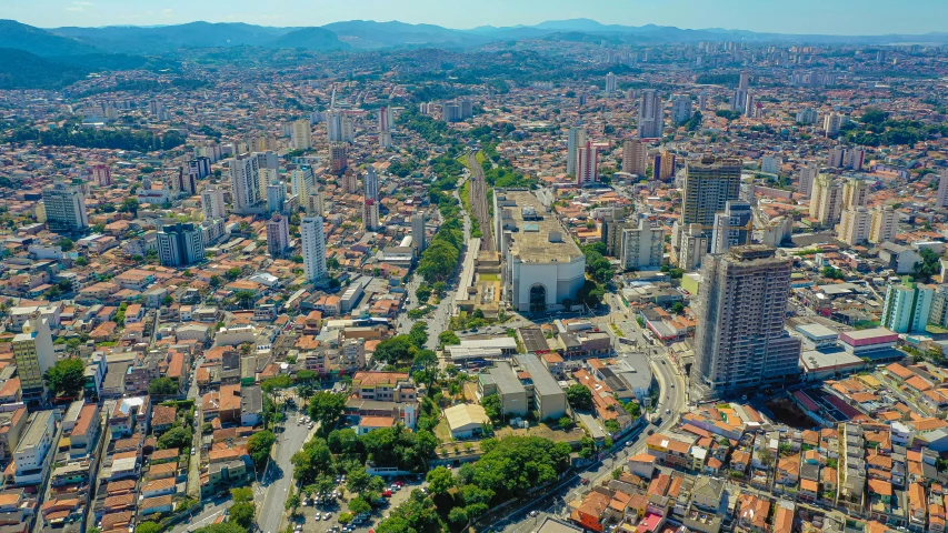 an aerial view of a big city with lots of buildings and mountains