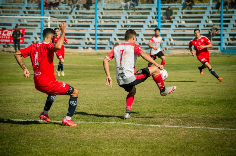 a group of young men playing soccer on a soccer field