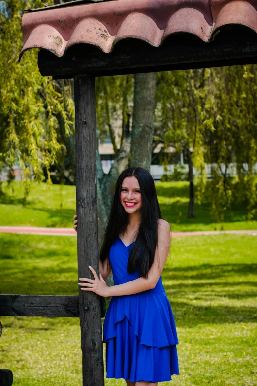 an image of a girl in a blue dress smiling