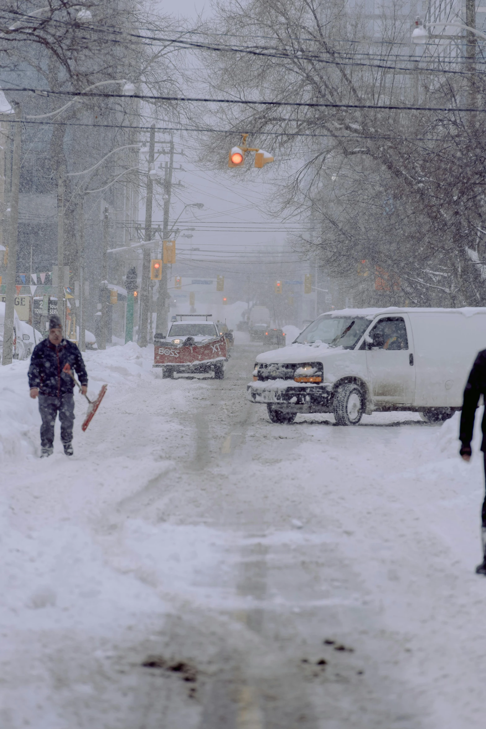 two people walk through a snowy street