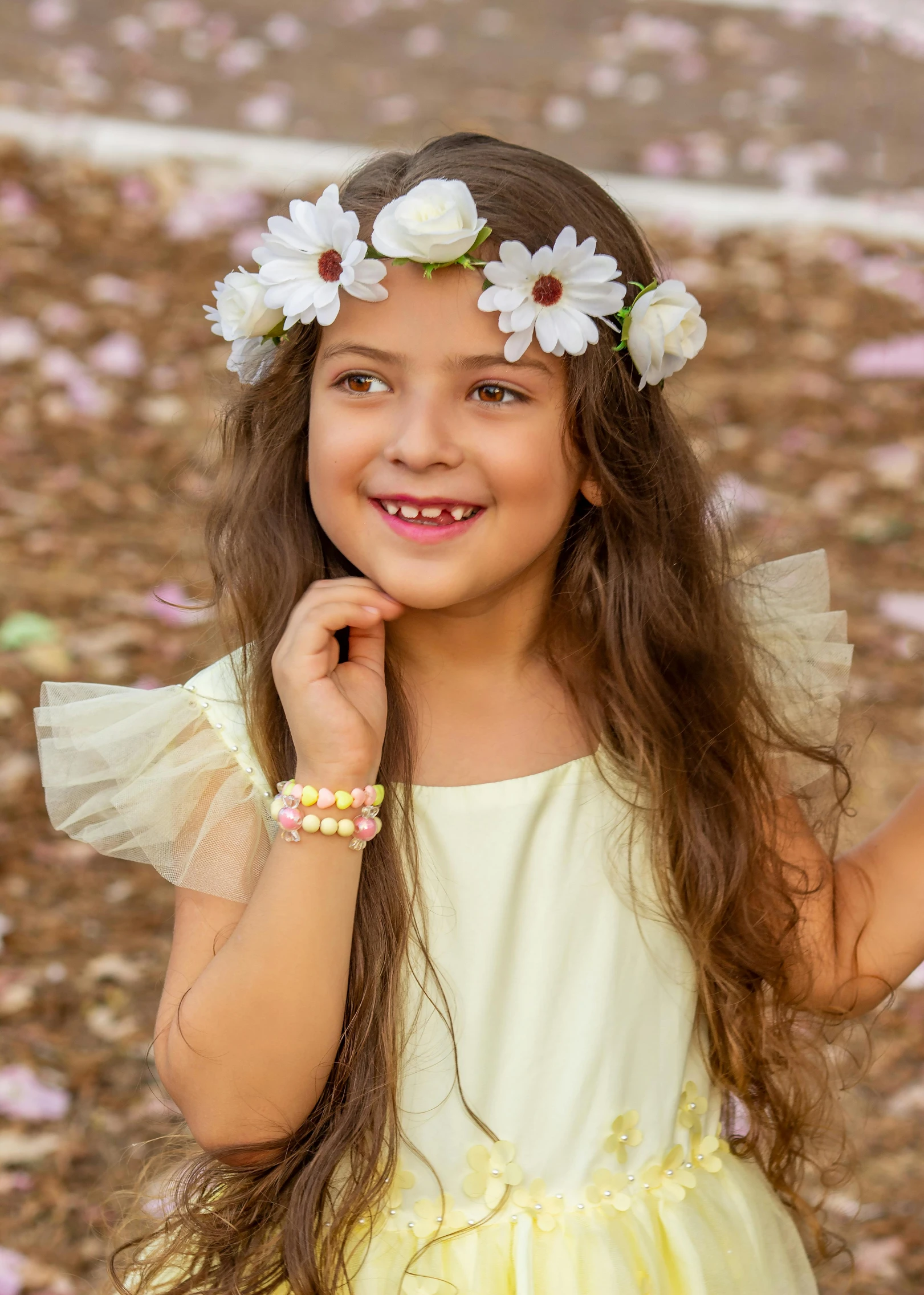 a small child with long hair and flowers in her hair