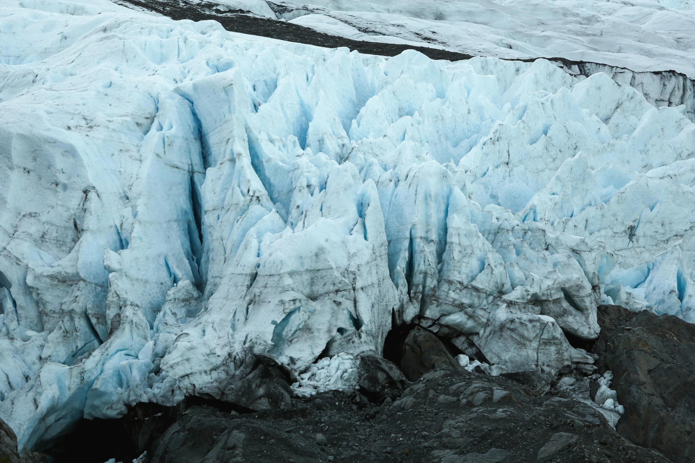 a large ice mountain next to mountains and ice