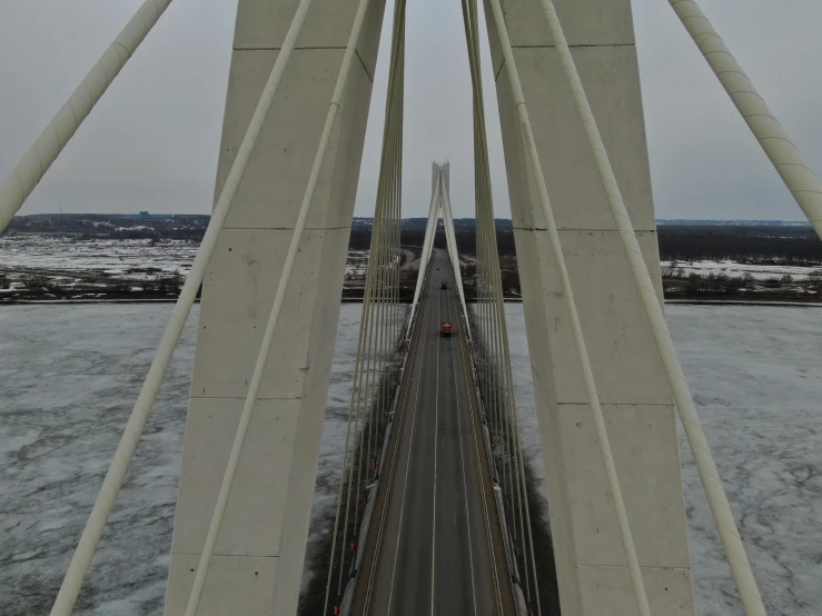 the view of a street bridge from above in the snow