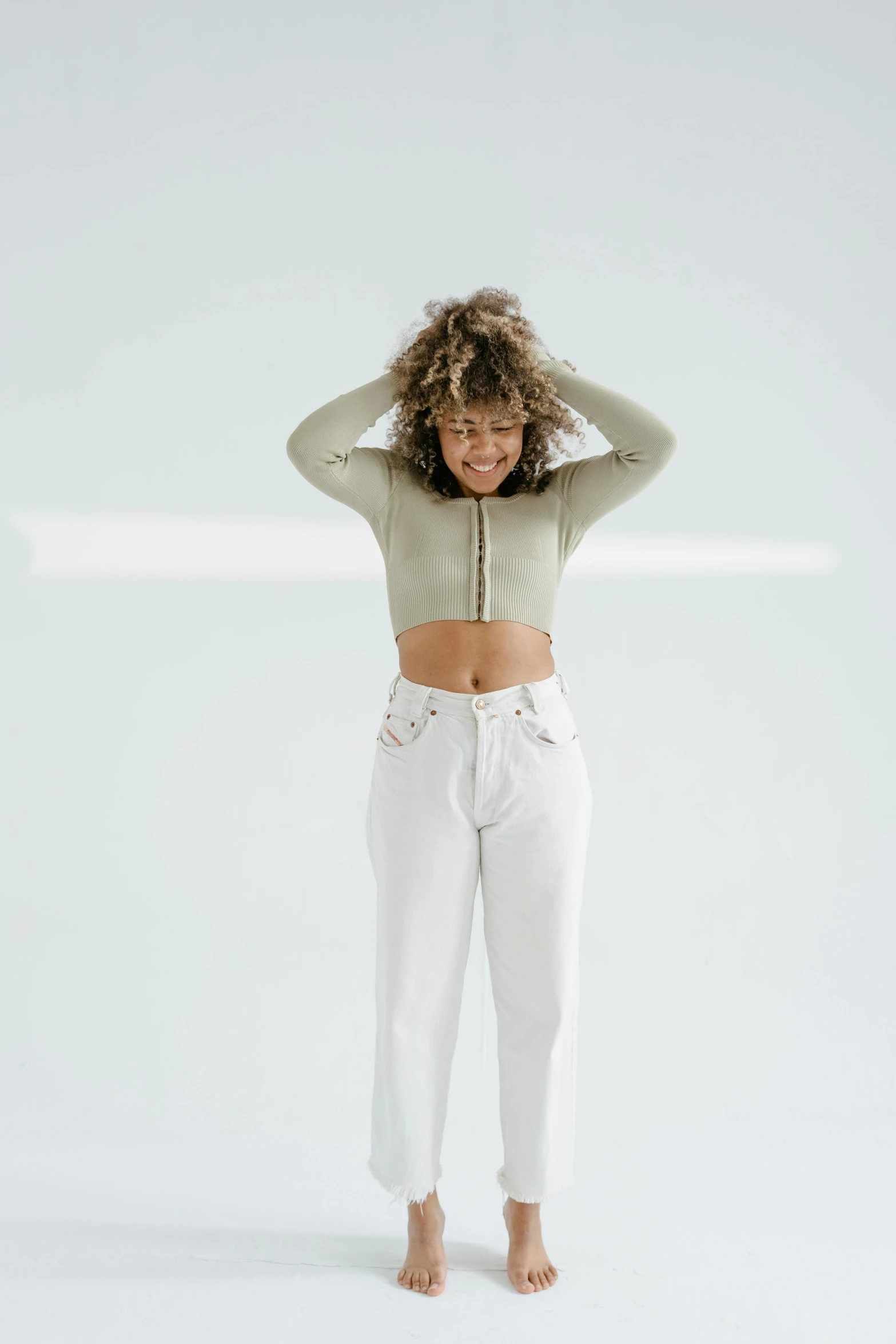 a woman standing with her hands on her head