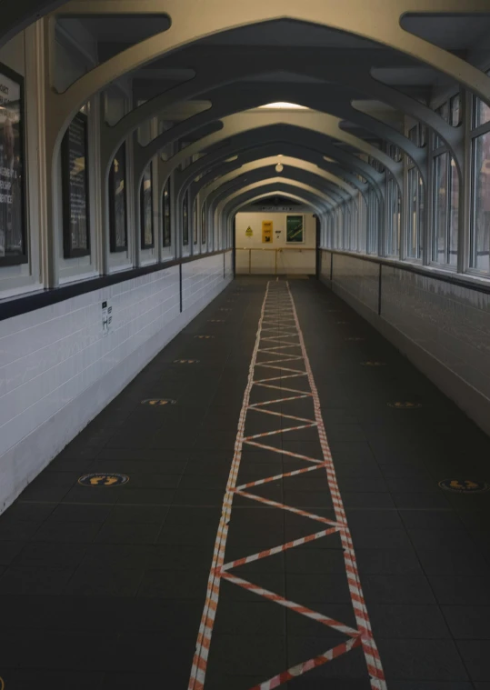 an indoor passage with some signs on it