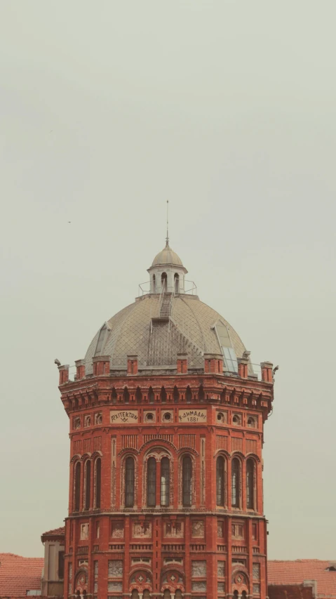 the dome on top of an old building has a clock on it