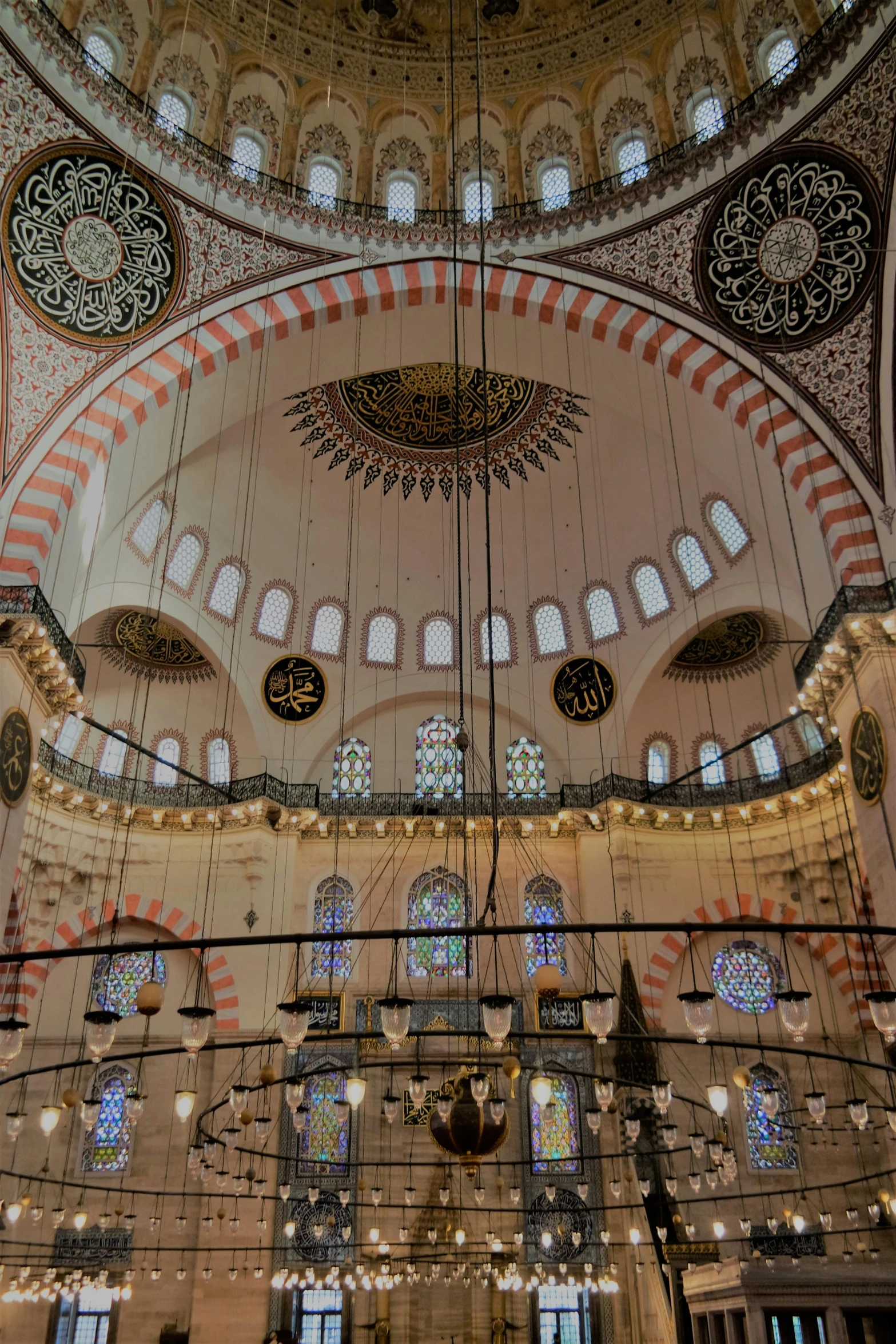 the ceiling is decorated with a pattern and ornate glass window