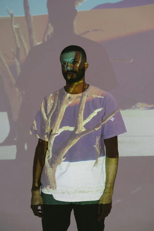 man in front of multi - colored tree picture in motion