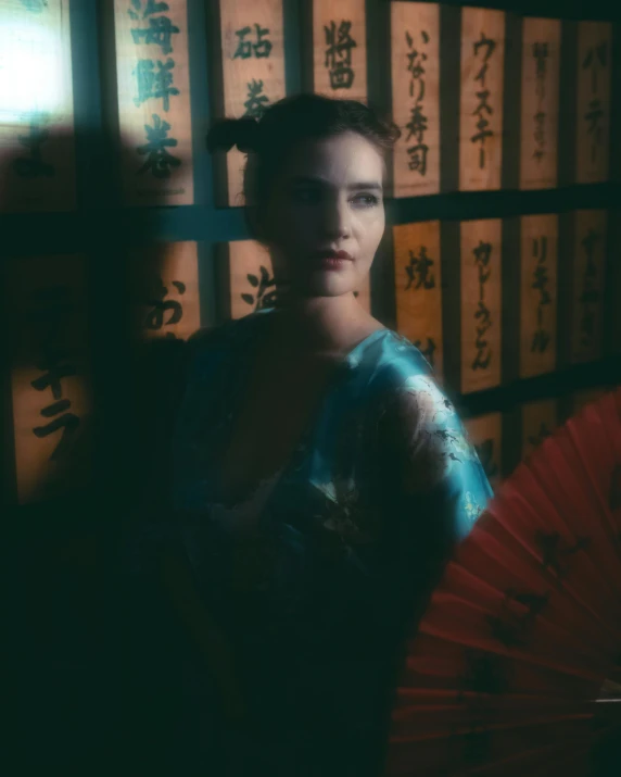 a woman holding an oriental umbrella posing for a pograph