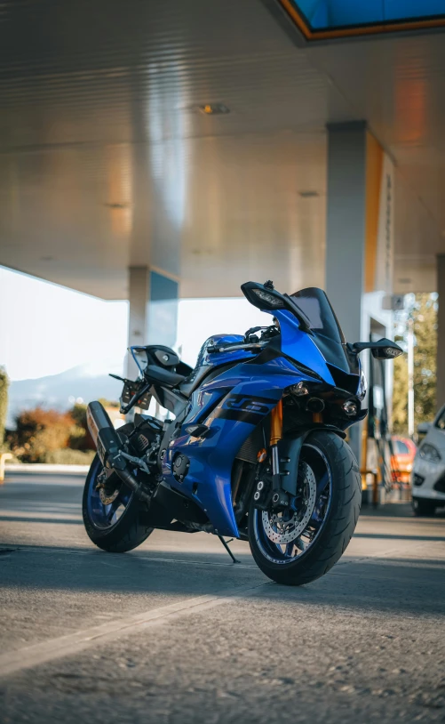 a motor bike parked in front of a gas station