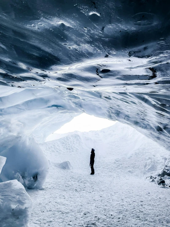 a skier standing on a snow covered mountain trail