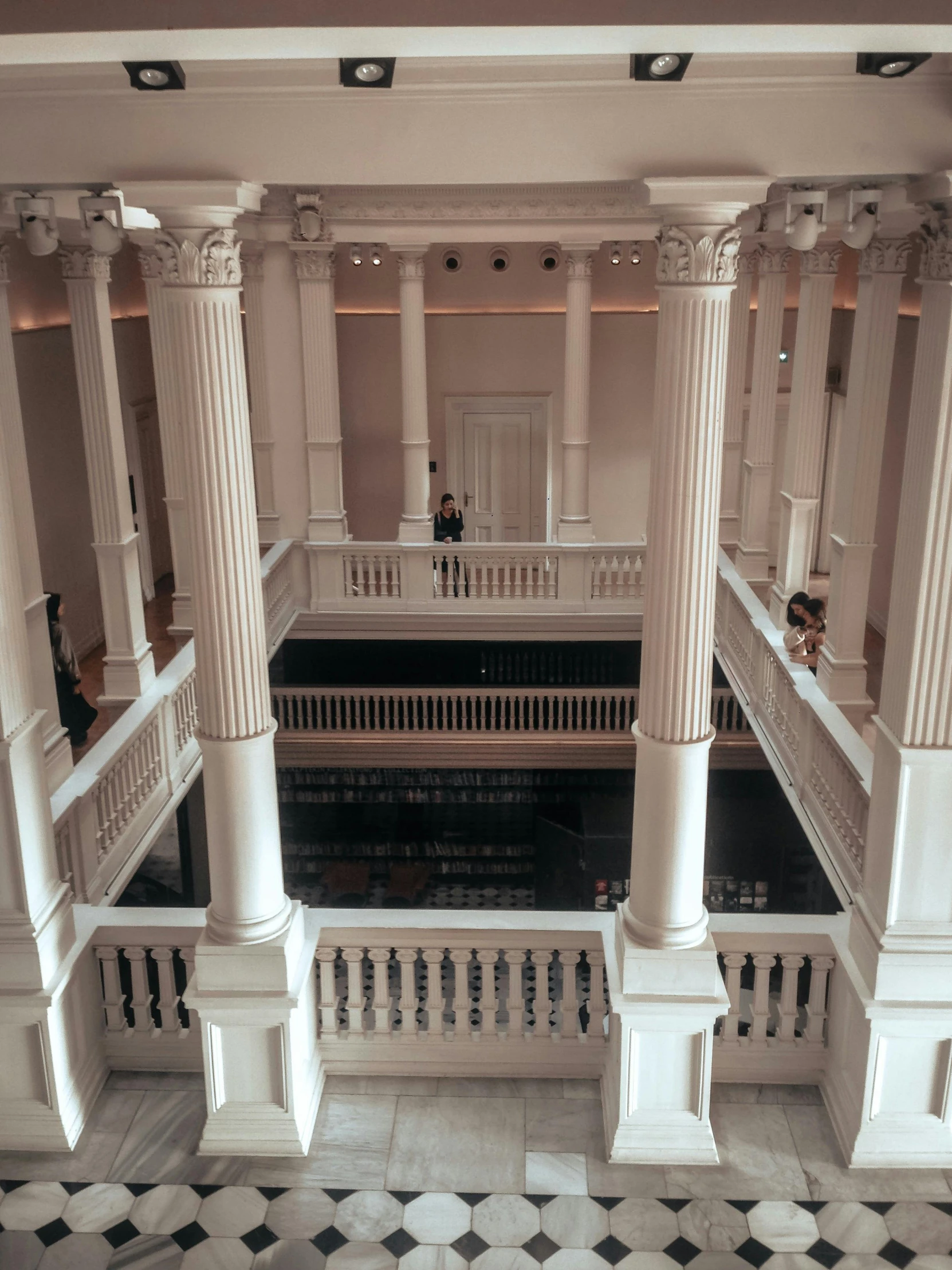 people standing around the lobby of an ornate building