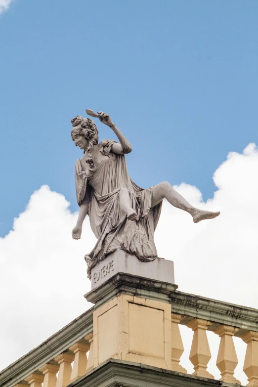 a statue of a woman on top of a building