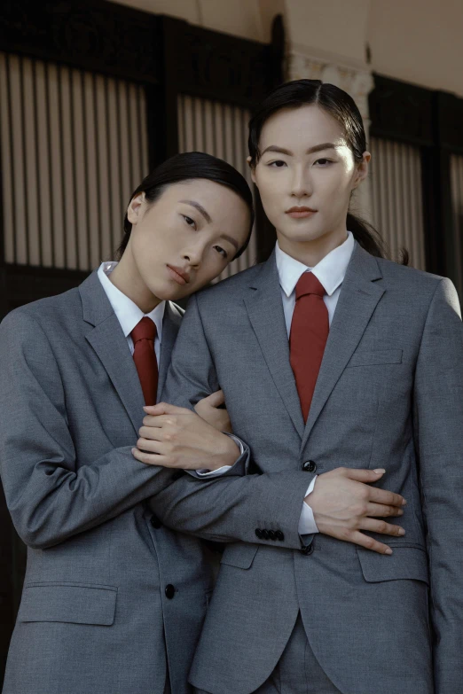 a couple of women in business suits standing next to each other