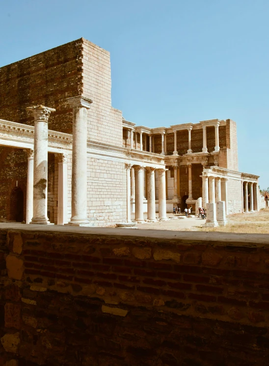 a building with pillars and a clock at the top