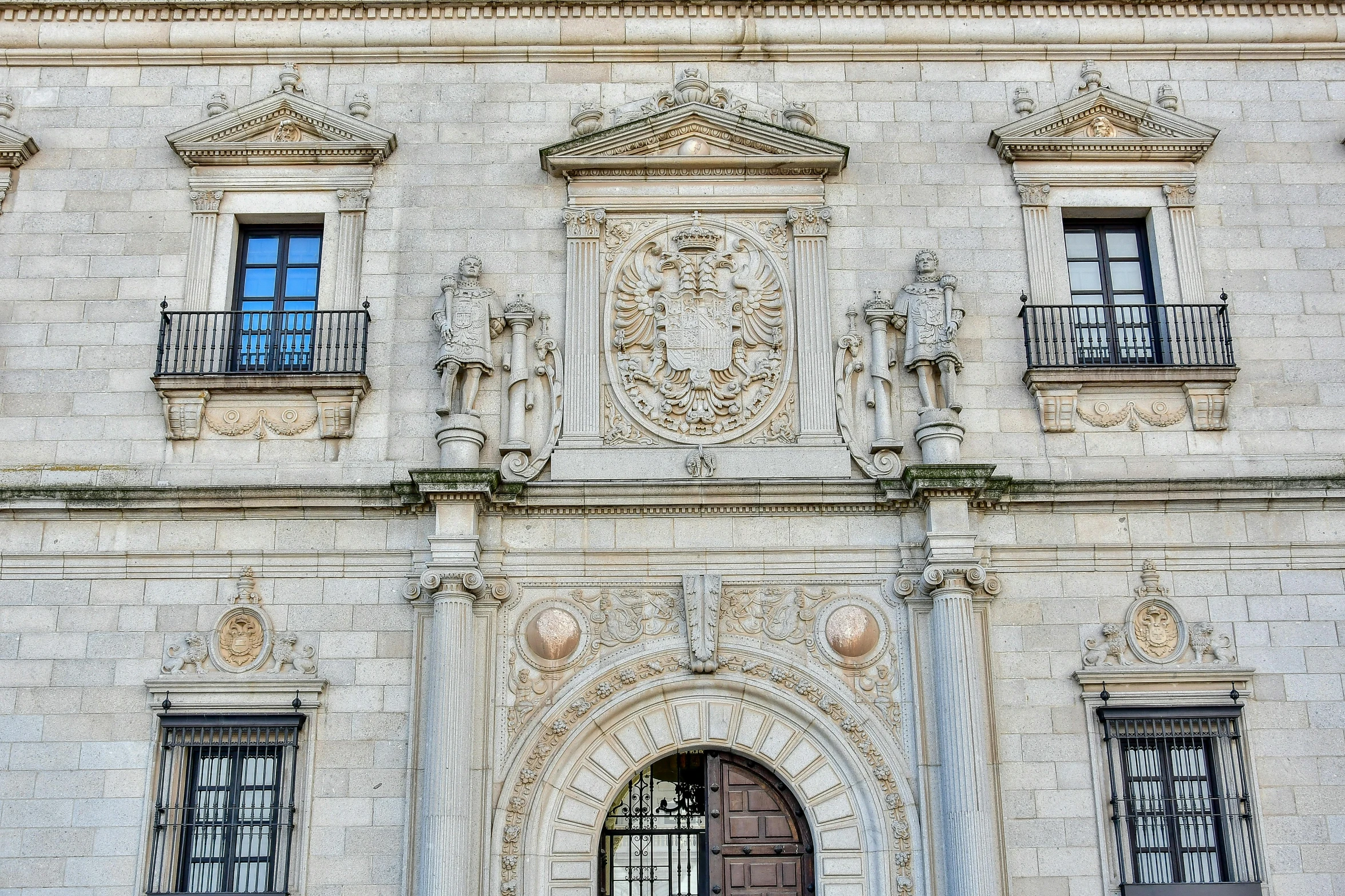 a large stone building has many windows and doors