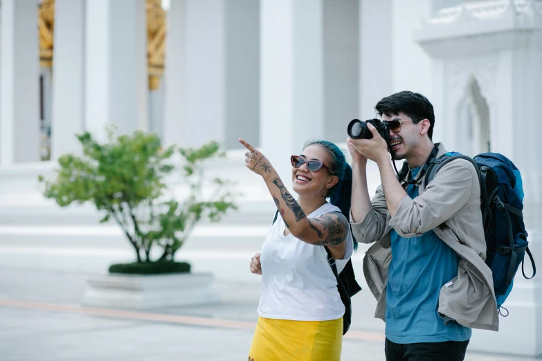 a man and woman are taking pictures on their cell phones