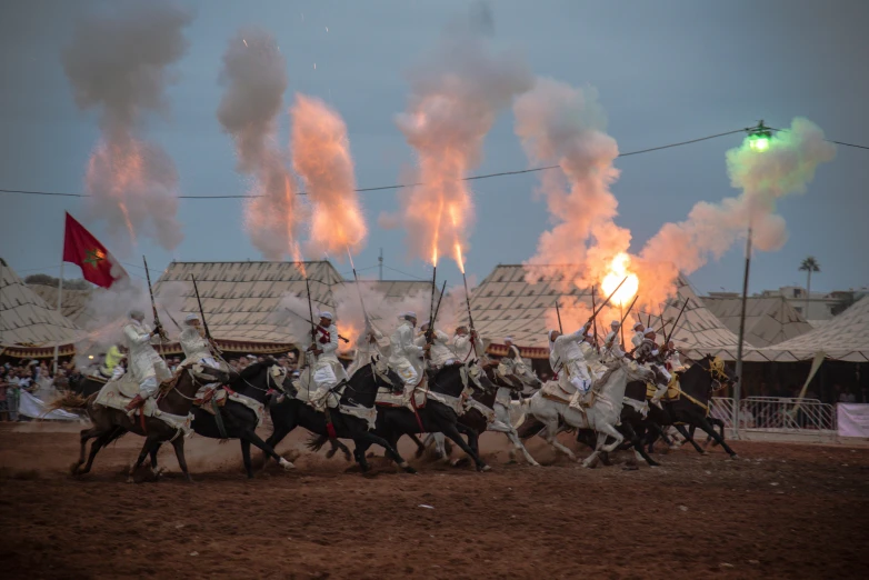 a bunch of men on horses playing battle