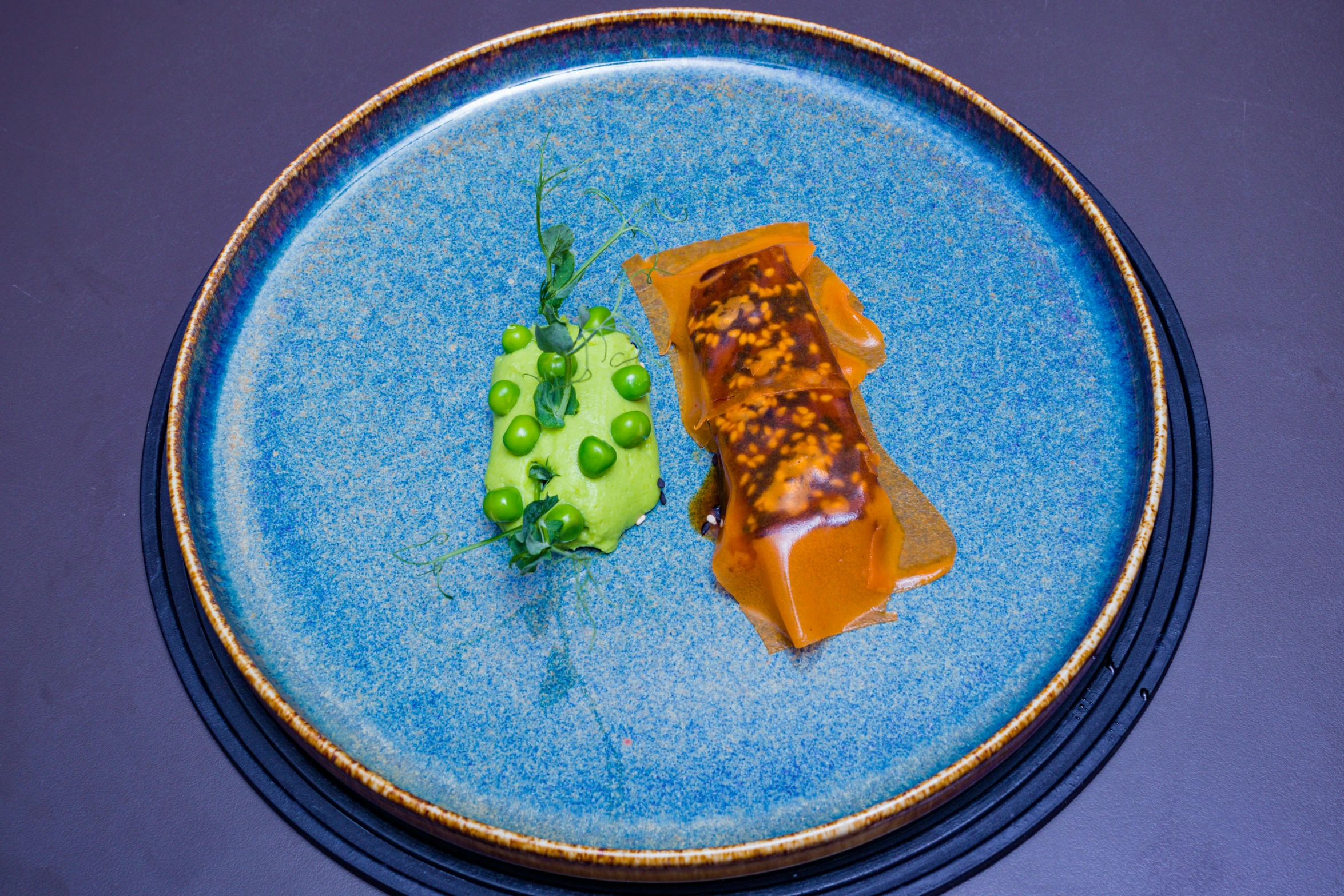 a small piece of chocolate sitting on a blue plate