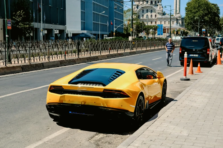 there is a yellow sports car stopped at an intersection