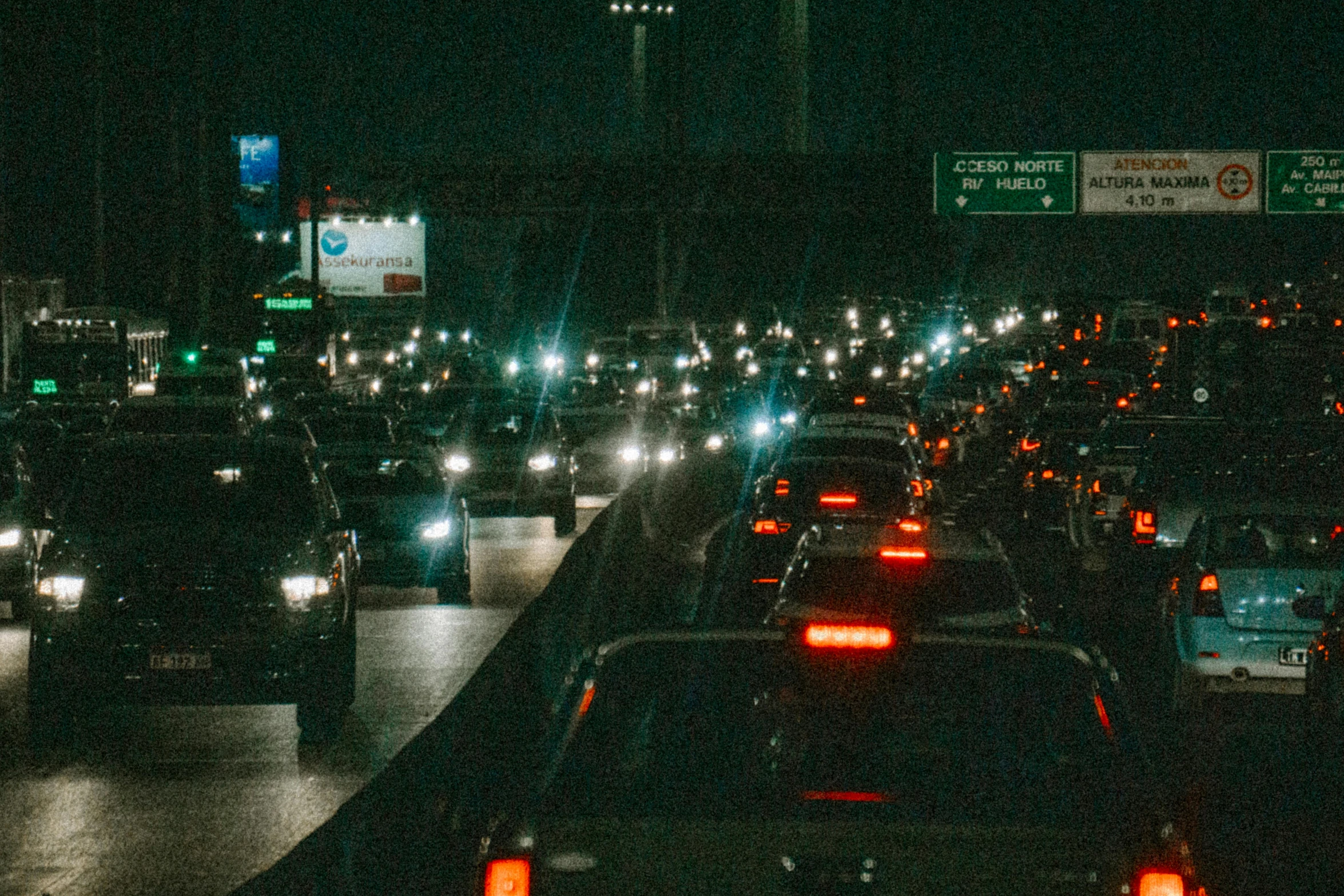 many cars in the middle of the road at night