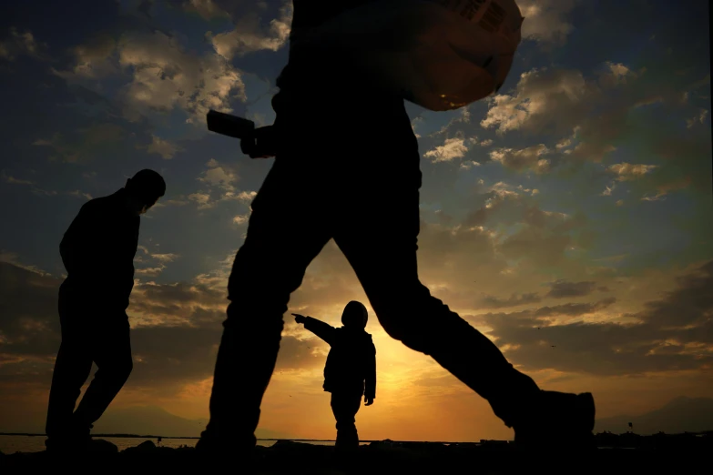 a man with a camera looking at the sunset