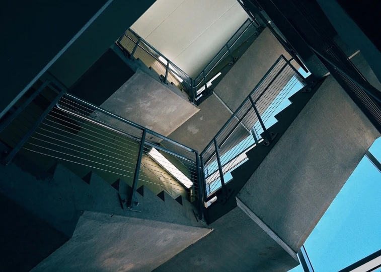 a staircase at night in the shadows of its lights