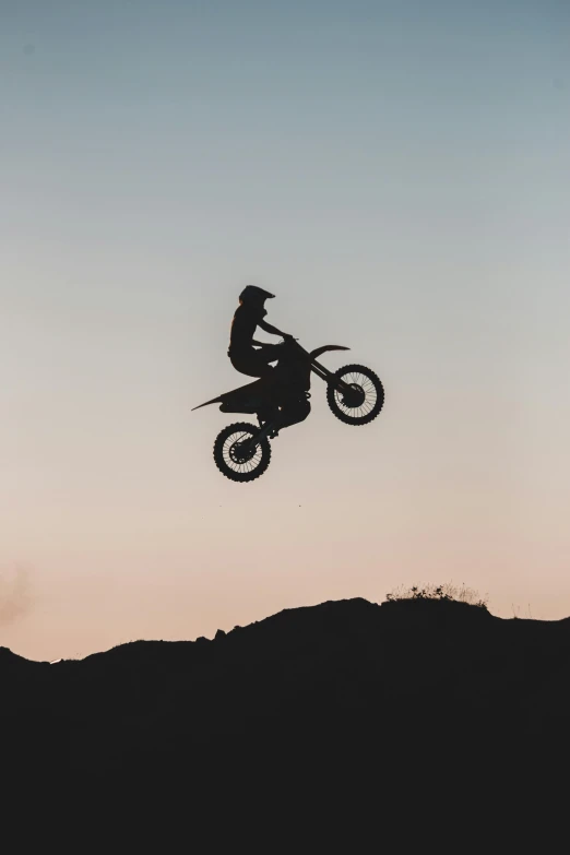a person on a dirt bike up in the air