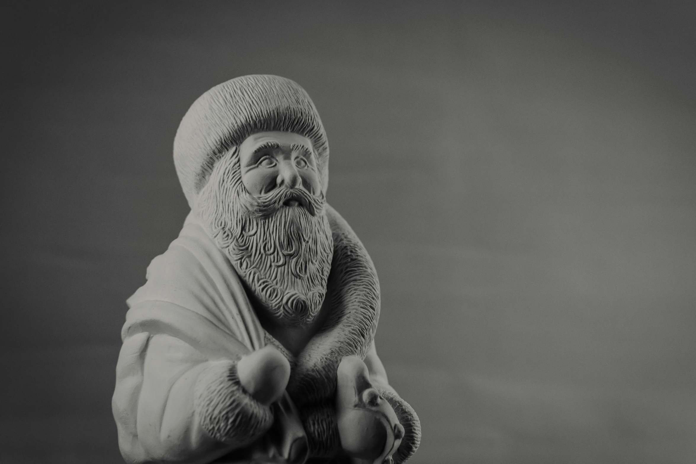 an old man in a long hat with a beard and white robe