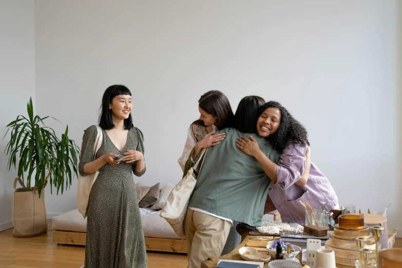 a group of people hugging in a room