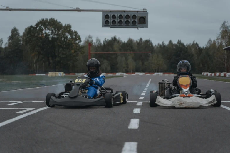 two people are racing go - carts around a curve
