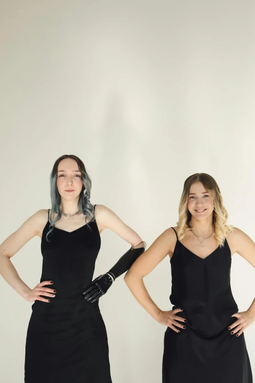 two woman are posing for a studio po