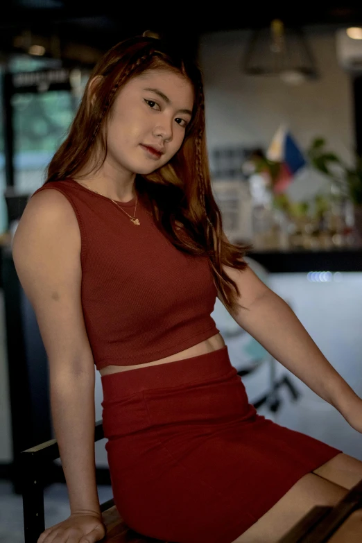 a woman sitting on a chair posing for a po