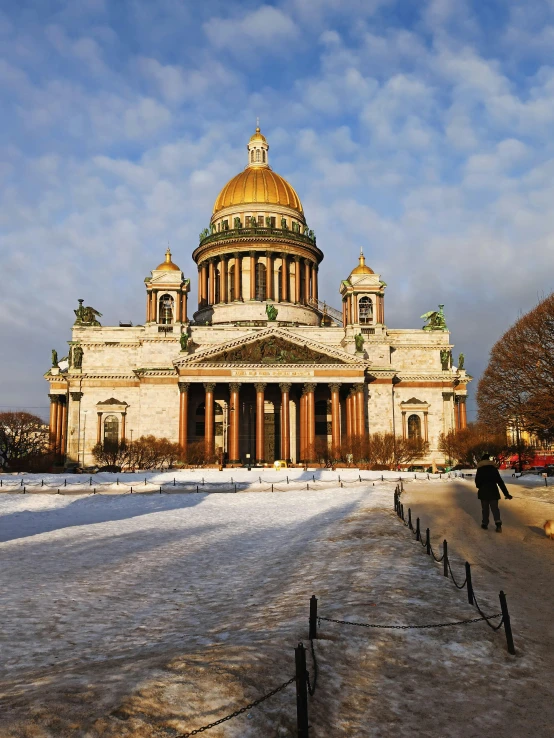 people walking around in front of a building on a snow covered field