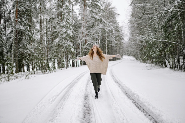 a girl standing in the middle of a road holding an umbrella