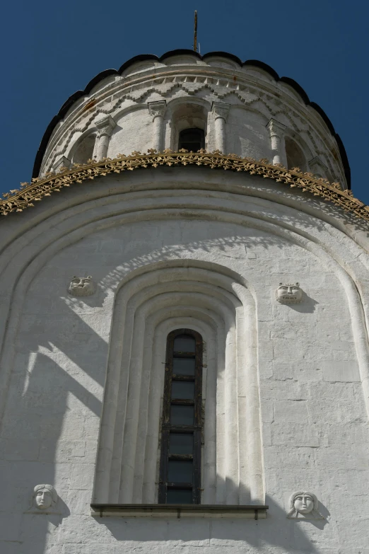 the dome on the building is white and gold