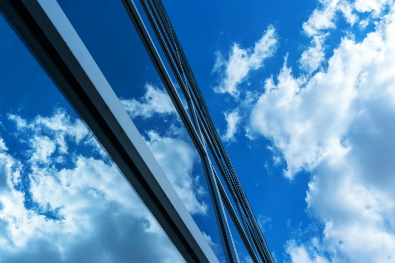 a street sign in front of a partly cloudy sky