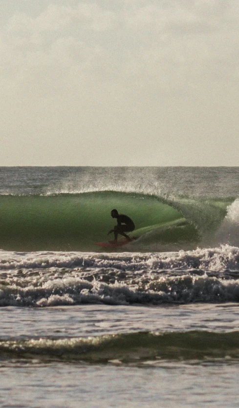 a person surfing in the ocean on a surfboard