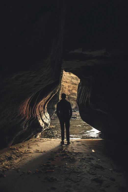 a man stands alone in an otherwise cavern