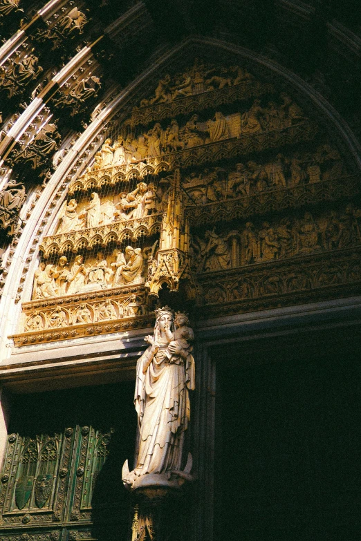 a statue of a woman holding a book in an arched doorway