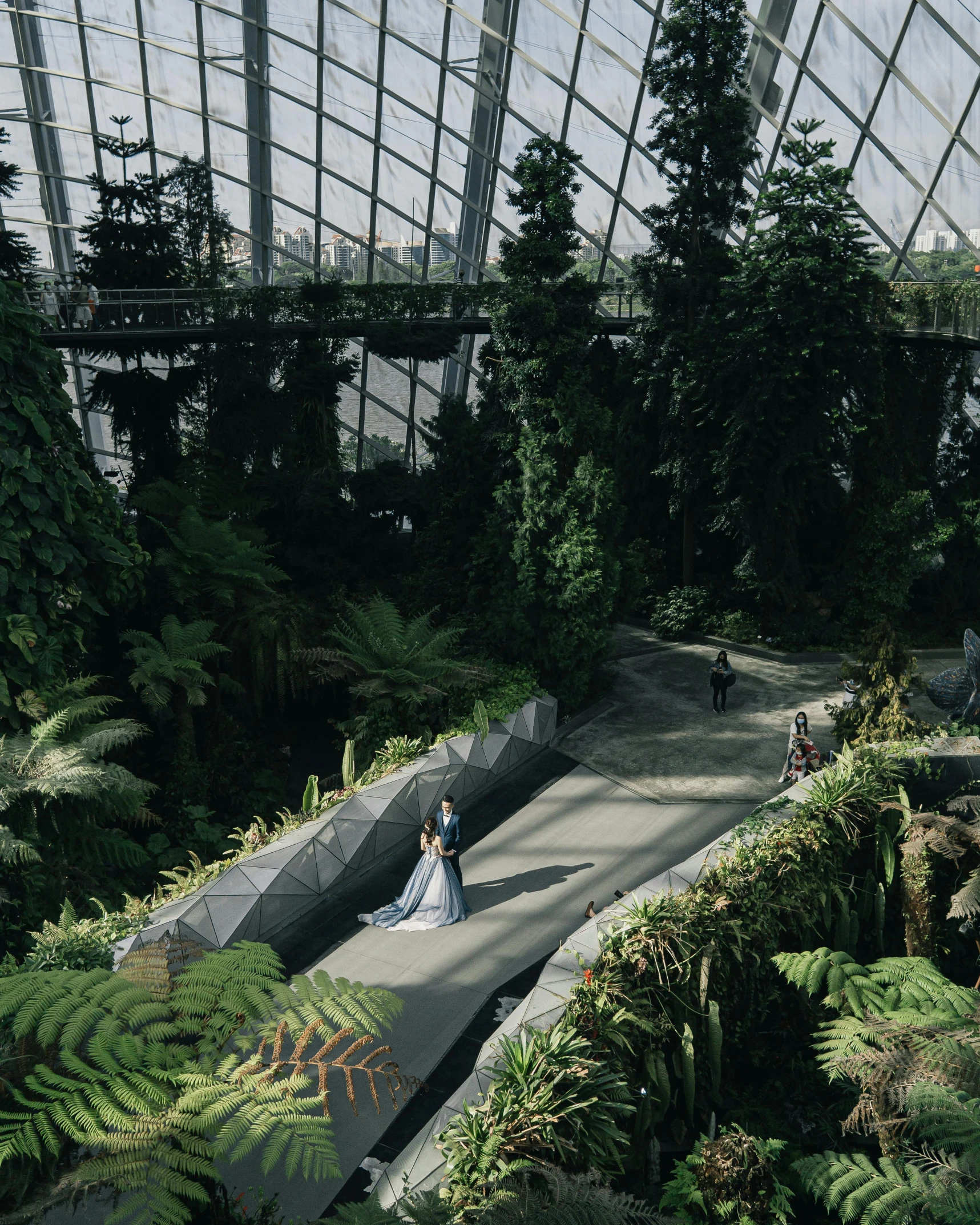 the bride and groom are standing on the walkway at the gardens of the bay