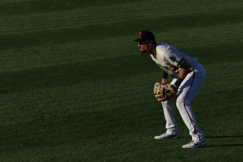 a baseball player in the outfield getting ready to catch the ball