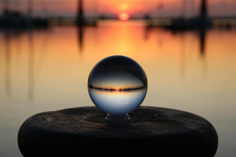 an unusual sphere sitting on a small rock