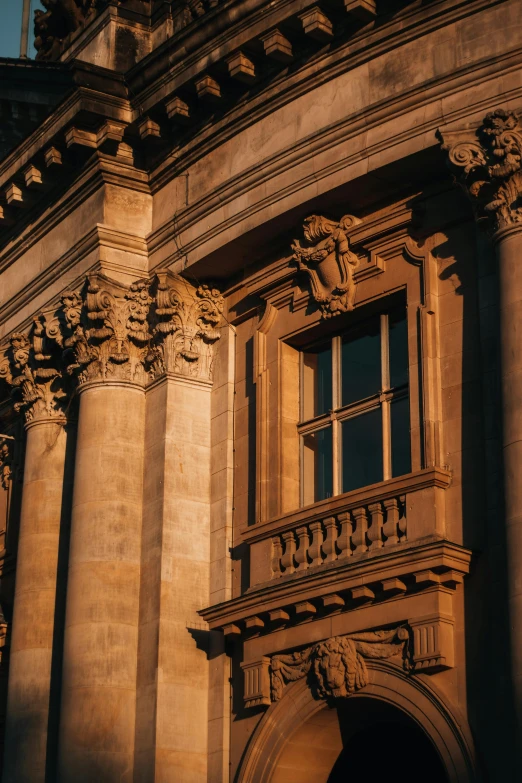 the sun shines on an old building with carvings and designs