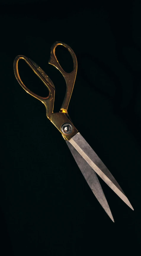 gold scissors sitting on top of each other